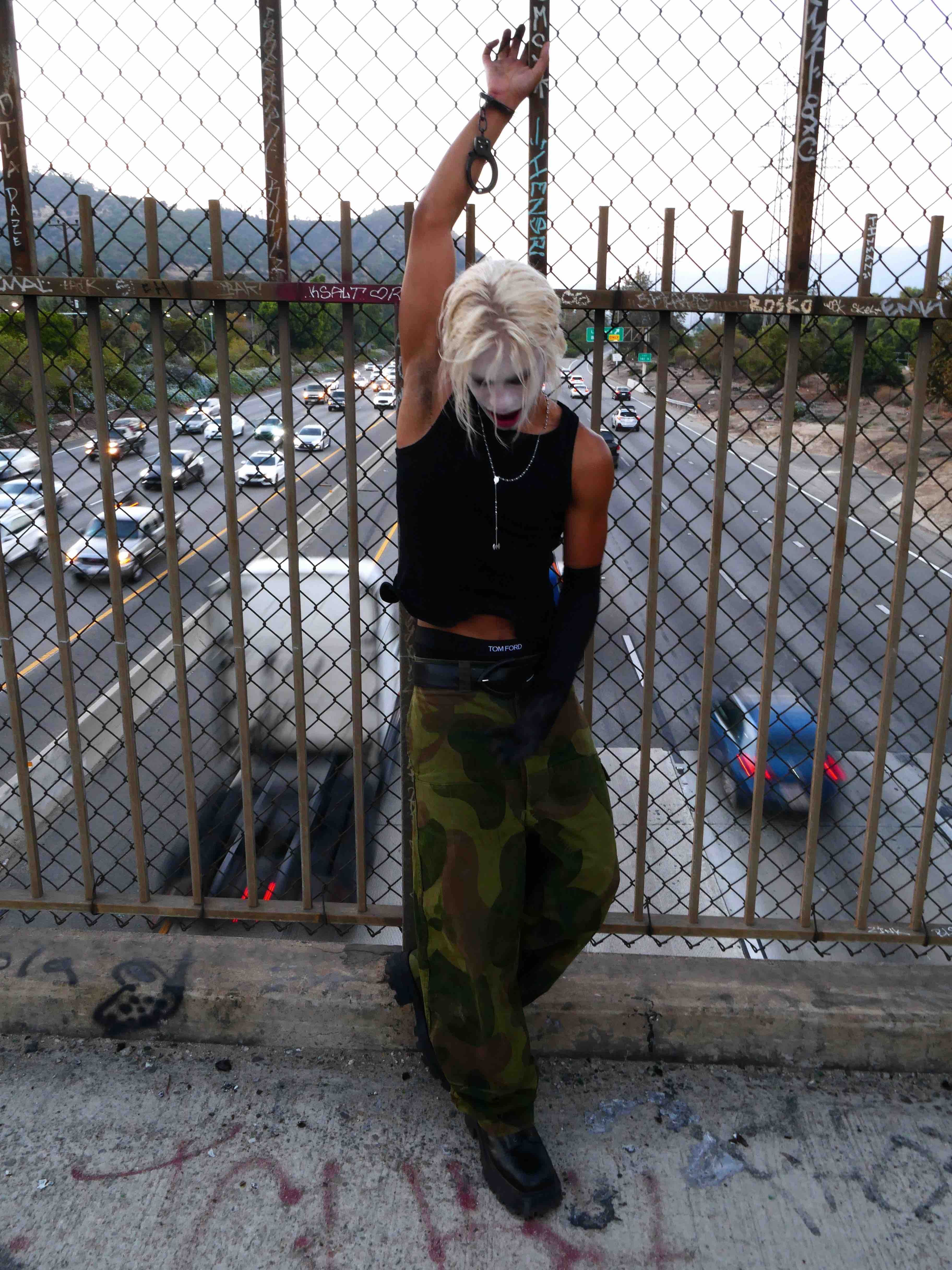 032c × Drain Gang — portrait by the fence, arm raised