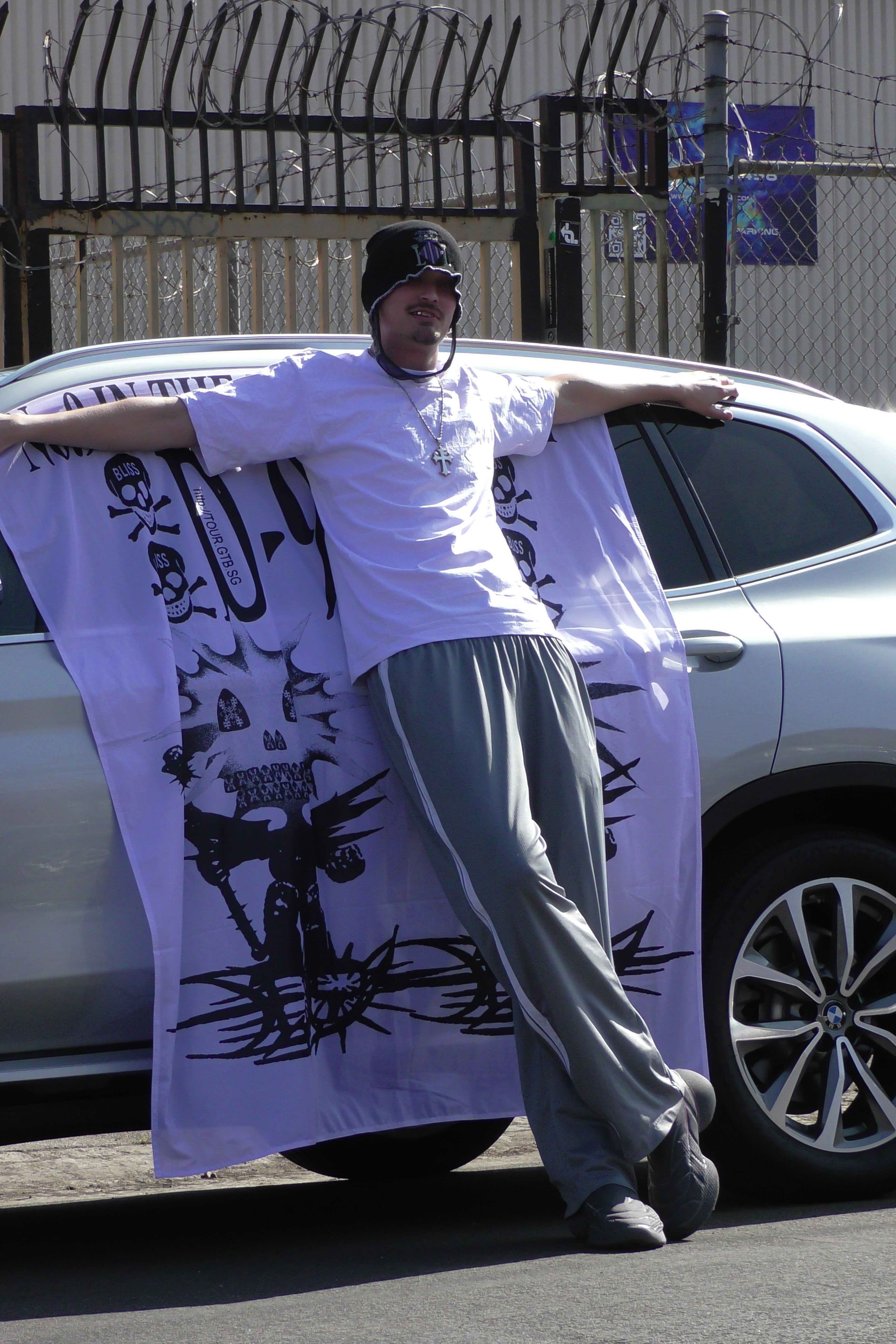 032c × Drain Gang — holding a banner by the car
