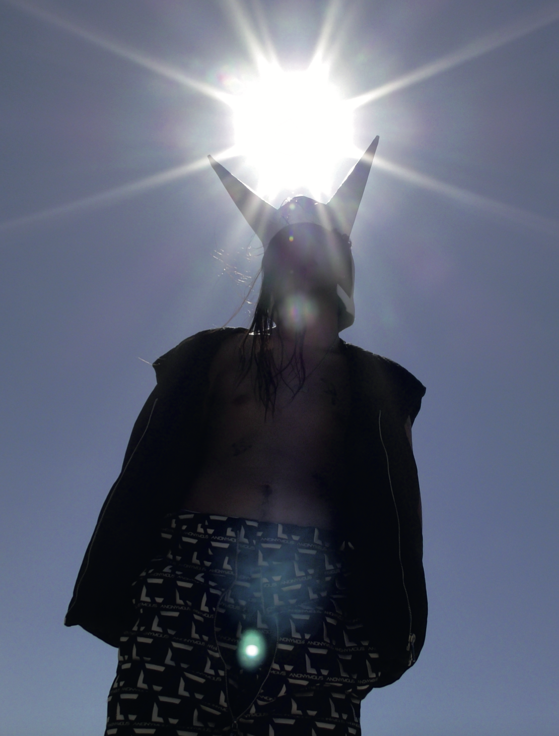 Hood By Air — Trust Exercise, sun-flare silhouette in a horned headpiece, the cover frame