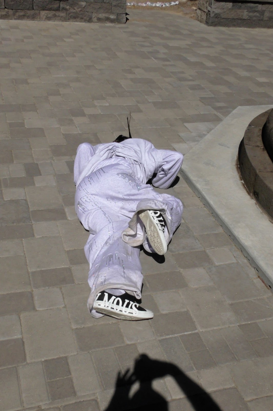 Hood By Air — Trust Exercise, figure lying on the paved ground, seen from above