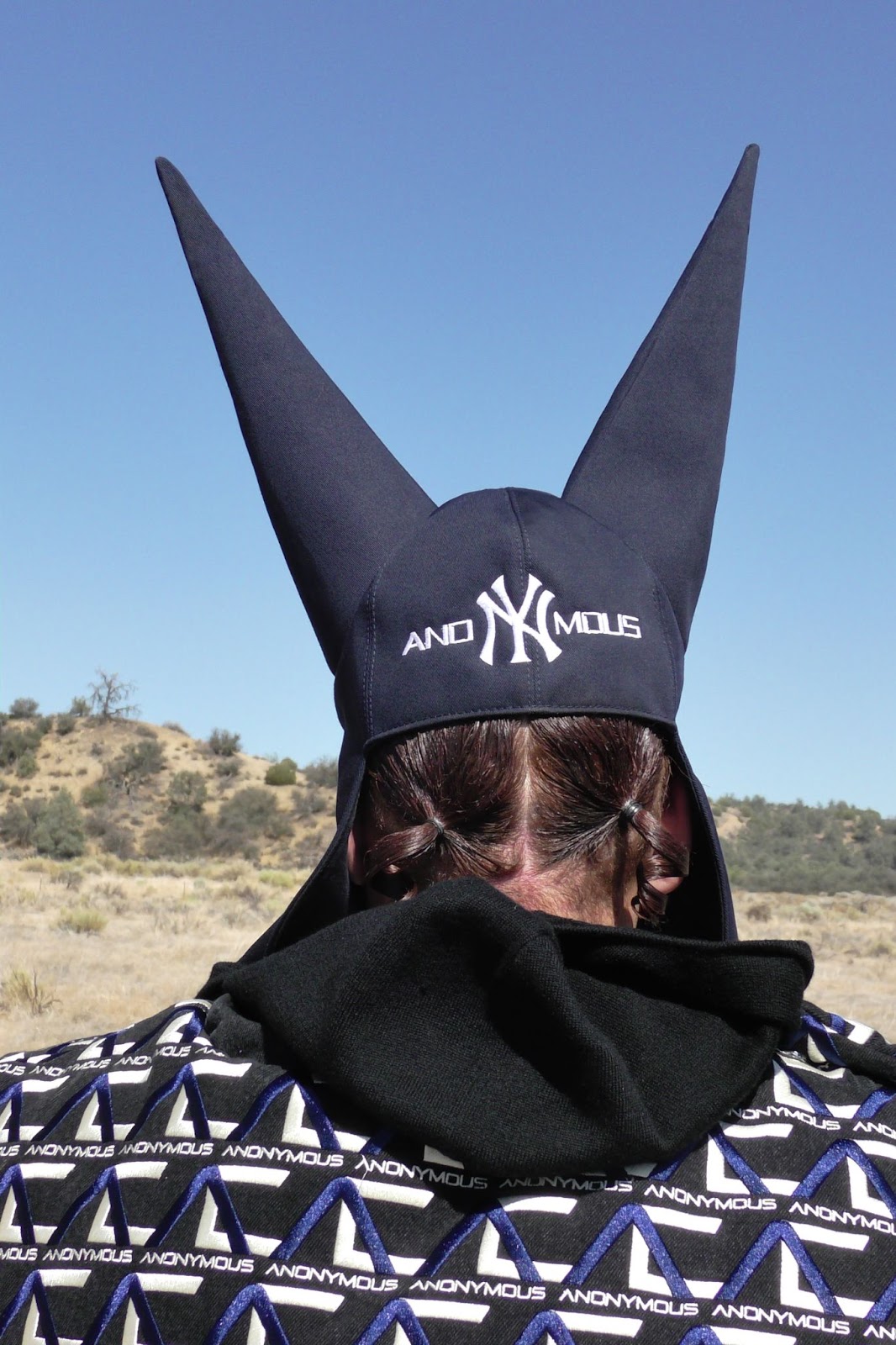 Hood By Air — Trust Exercise, horned cap and monogram top, face covered