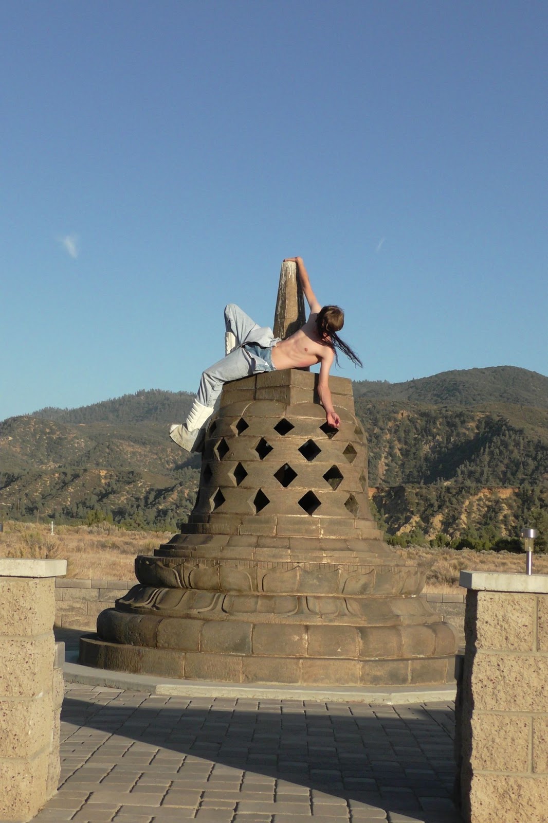 Hood By Air — Trust Exercise, figure climbing the stone monument