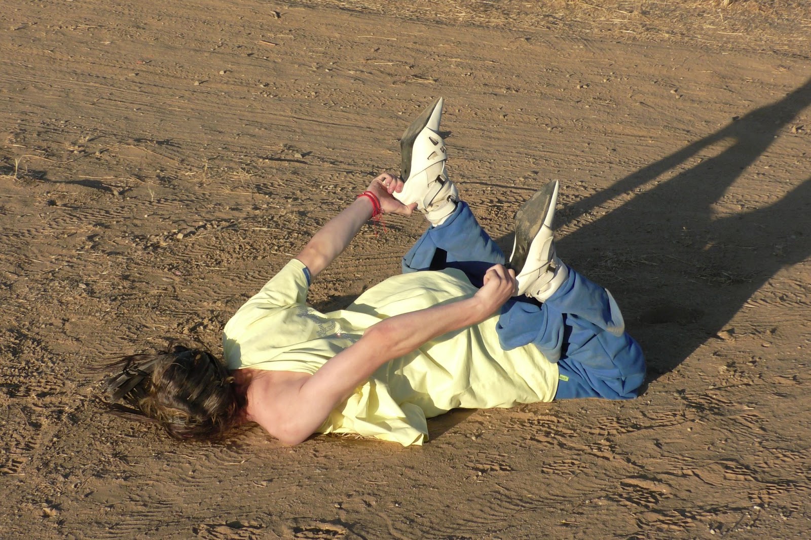 Hood By Air — Trust Exercise, figure lying on the sand in yellow and blue