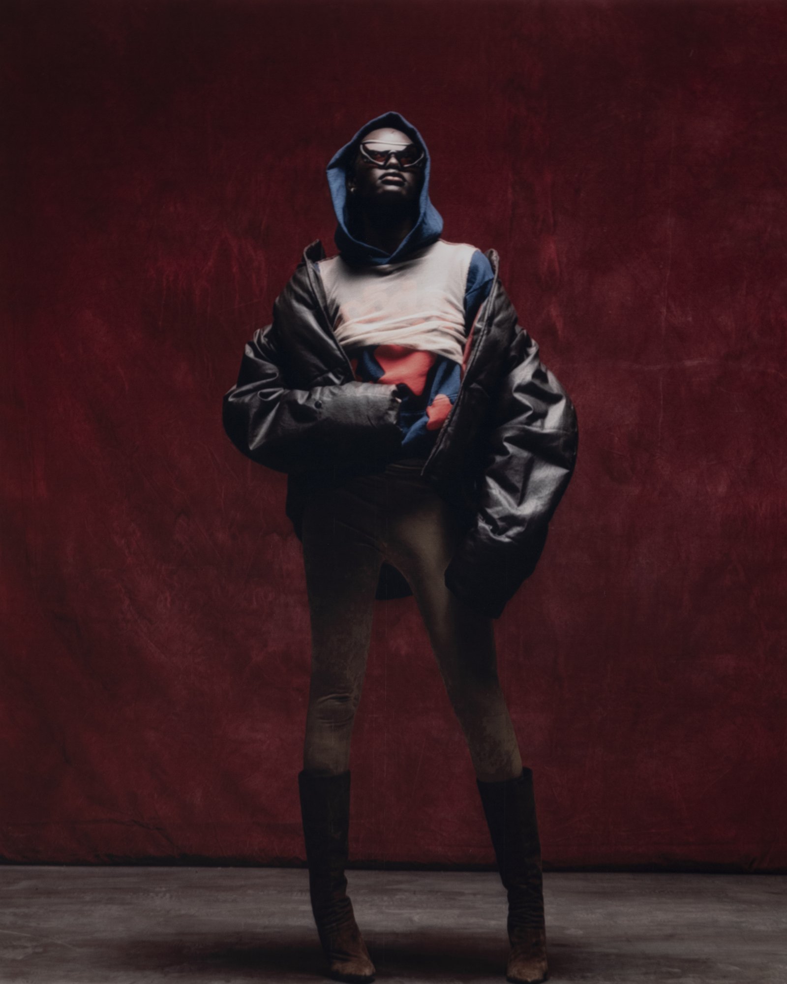 Sp5der — campaign photograph, puffer jacket full length on red